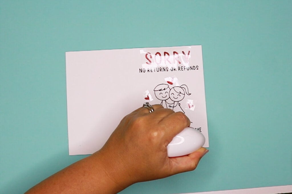 Apply the iron on vinyl to the card using a mini heat press.