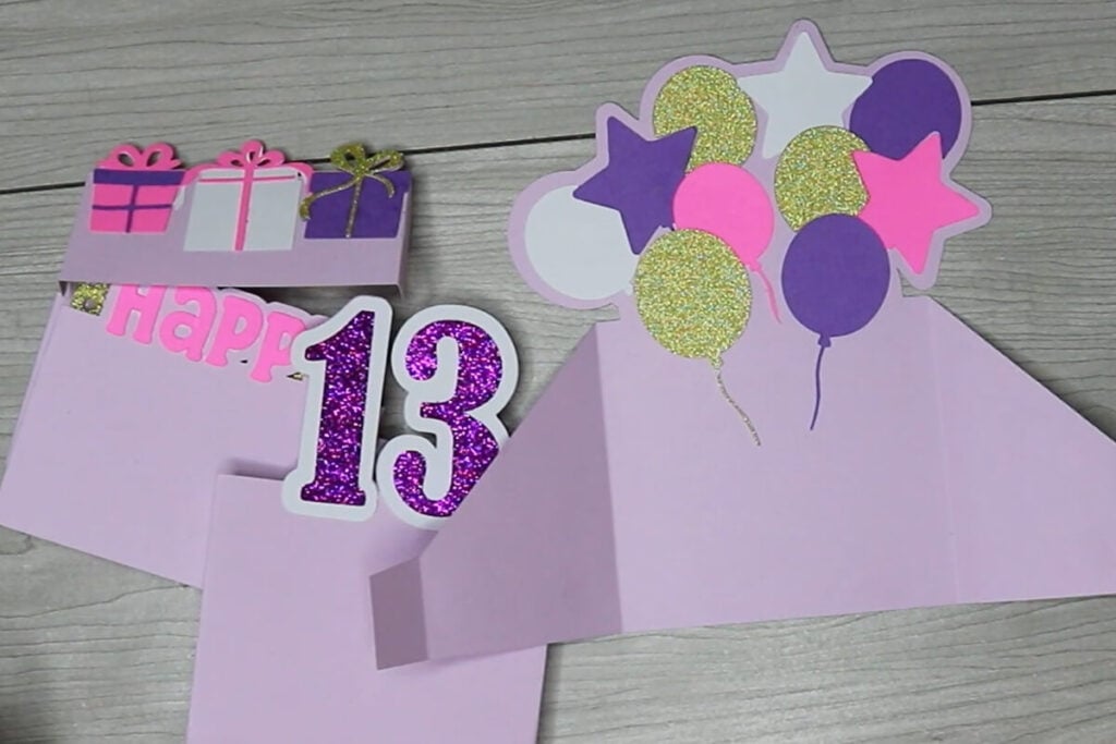 Glue decorative pieces to each of the box card pieces.