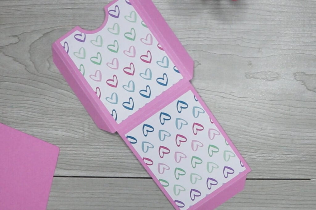 Glue scrapbook paper to front and back of template