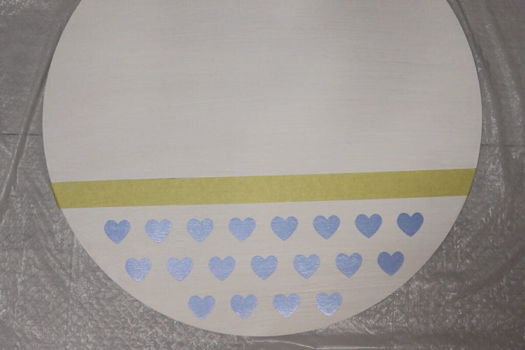 Apply stencil onto the wood round